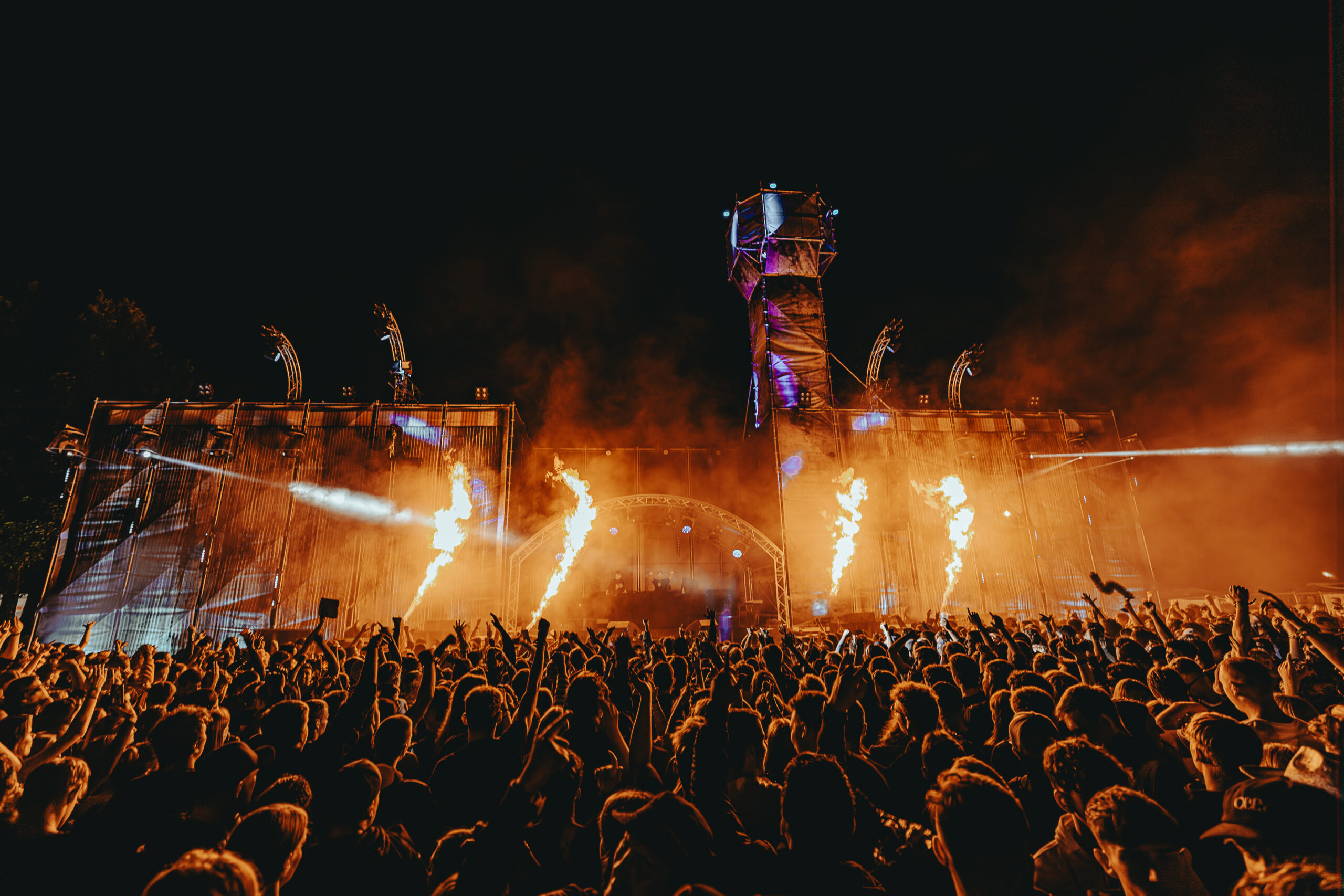 HOME Große Festival Bühne mit flammen Projektoren und Feiernder Crowd